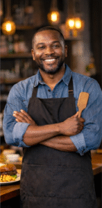 African American chef and restaurant owner preparing food in a professional kitchen in Hampton Roads